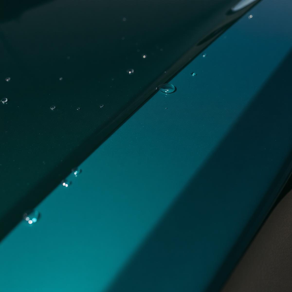 Water beading on a freshly waxed dark green hood